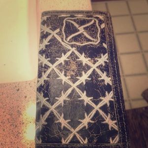 A wallet that has wa beat up wester look to it